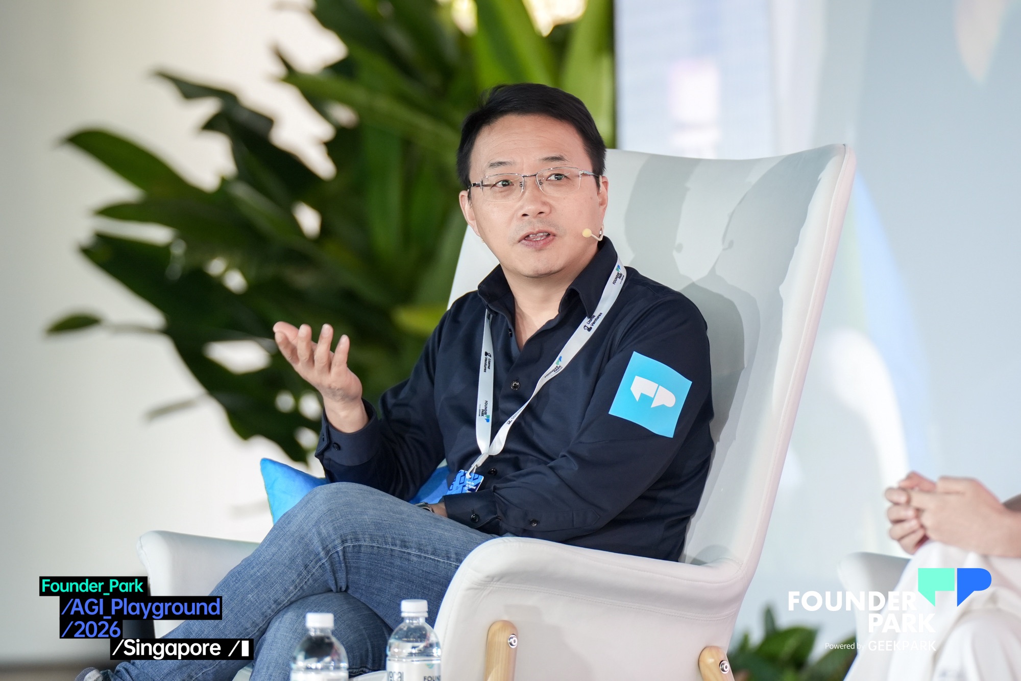 WIZ.AI CEO Jianfeng Lu speaking on stage at AGI Playground 2026 in Singapore